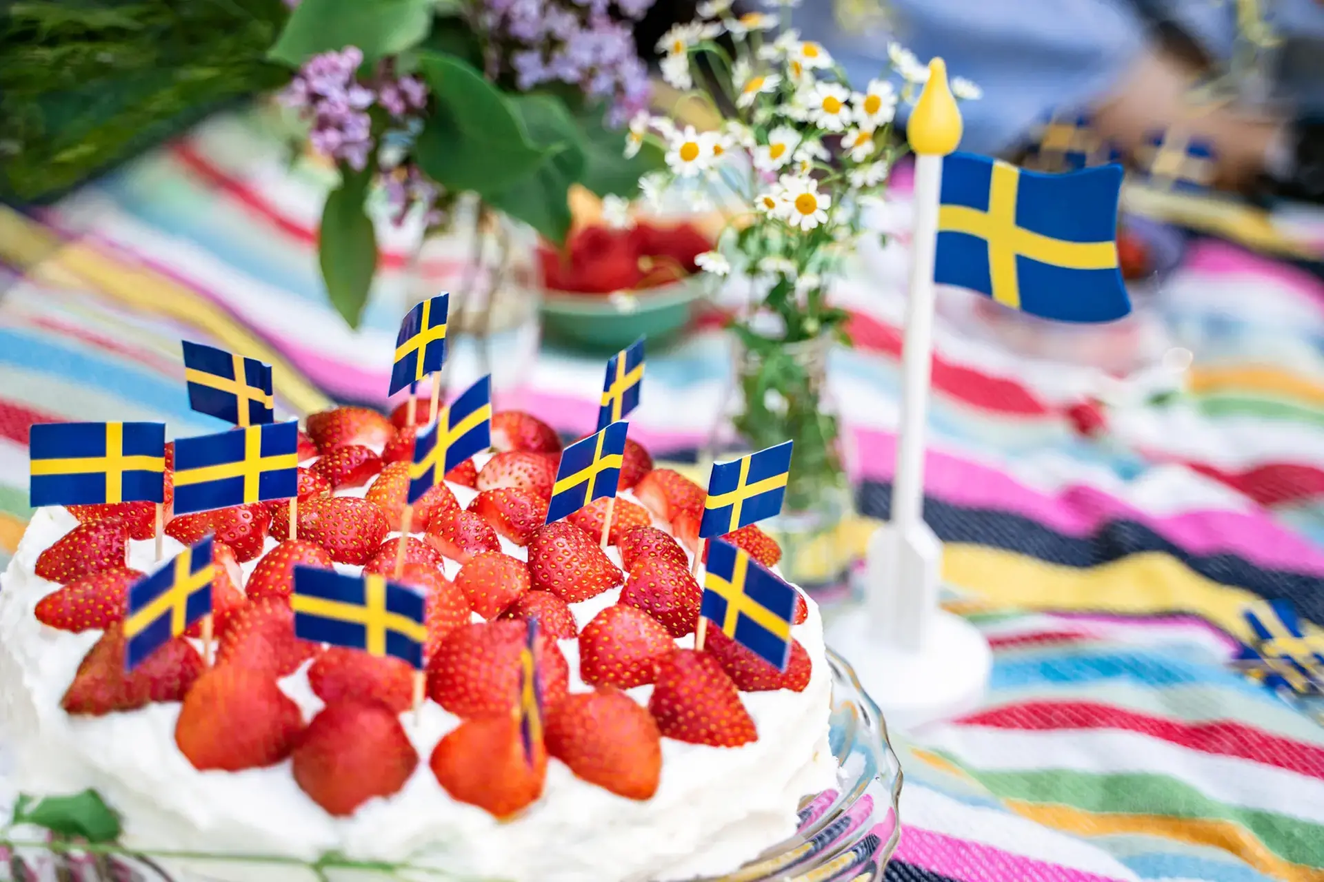 Cream cake with strawberries and Swedish flags as decoration